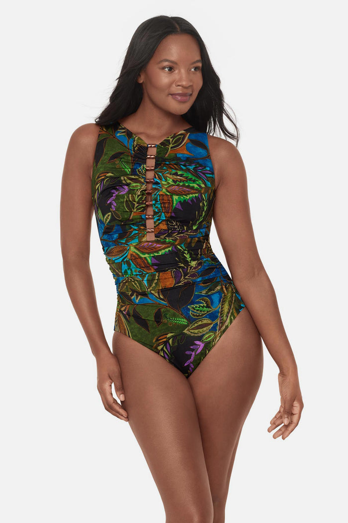 Woman wearing a multicolored abstract tropical printed one-piece swimsuit with beaded cutout detail down the front