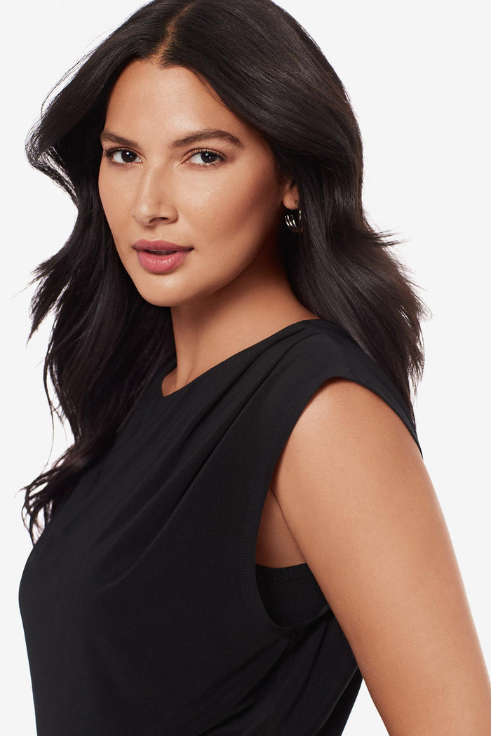 Close up of woman wearing a drapey black blouse