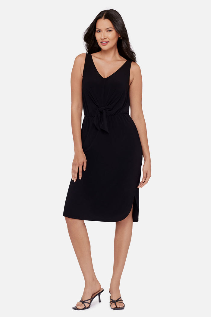 Woman wearing a black sleeveless mid length dress