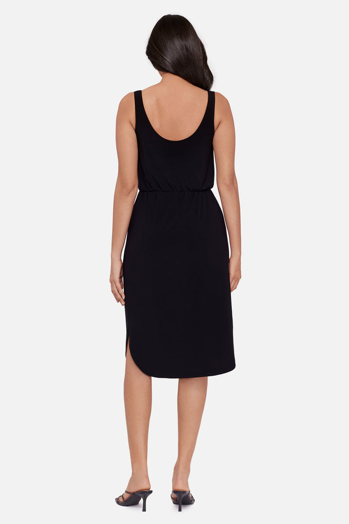 Woman faced away wearing a black sleeveless mid length dress