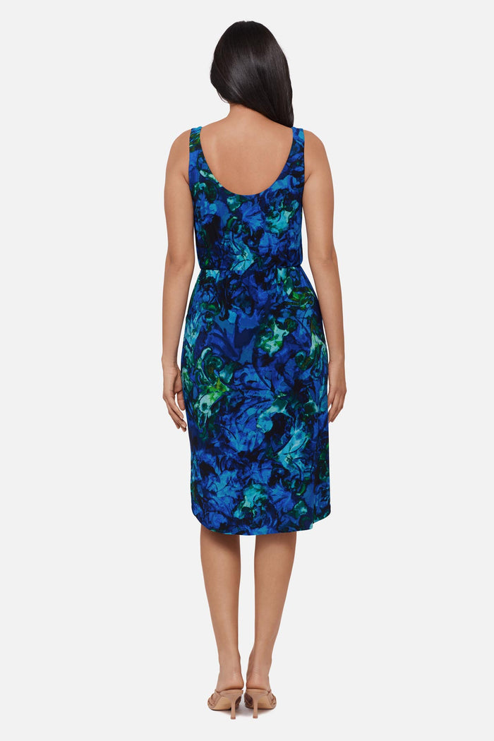 Woman faced away wearing a blue celestrial printed sleeveless mid length dress