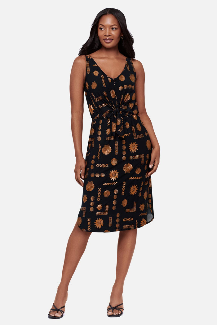 Woman wearing a brown and black shell printed sleeveless mid length dress