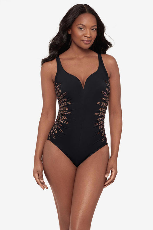Woman wearing a black one-piece swimsuit with brown streaking on each side
