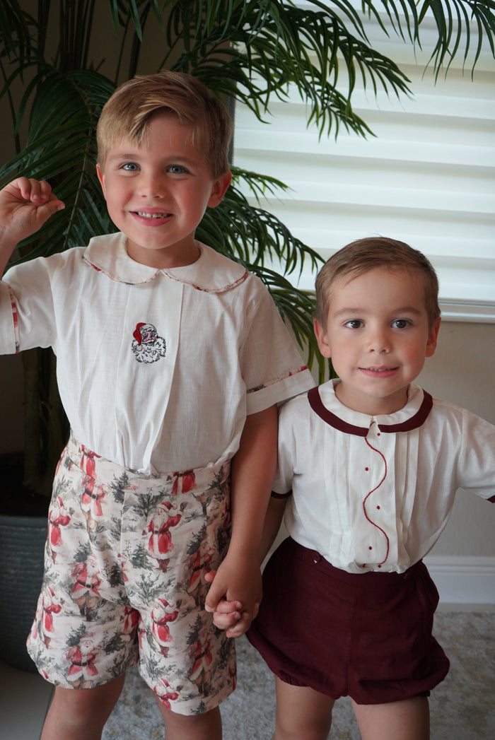 Boys wearing coordinating Santa Claus Christmas outfits