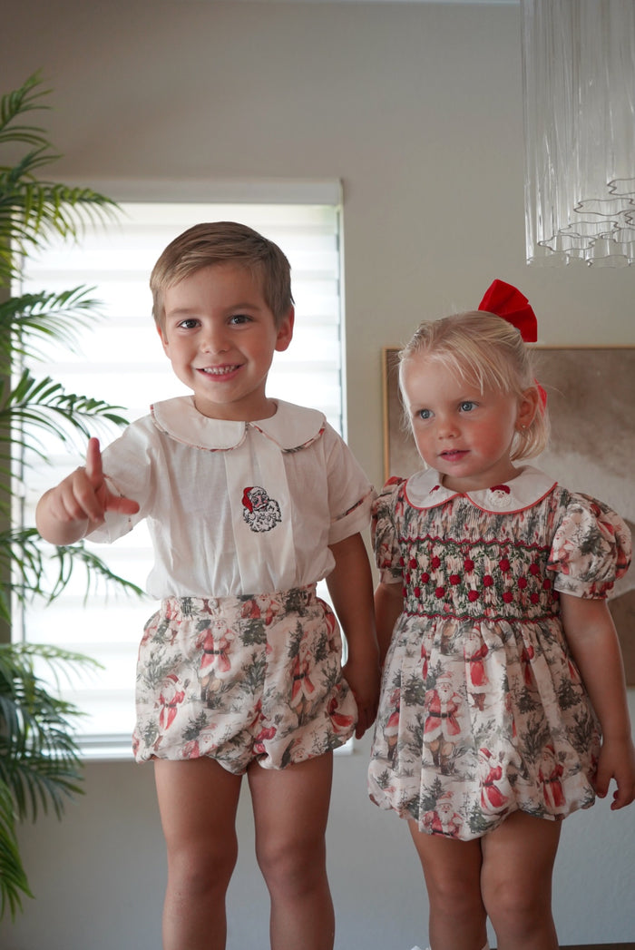 Children wearing coordinating The Santa Claus Christmas outfits