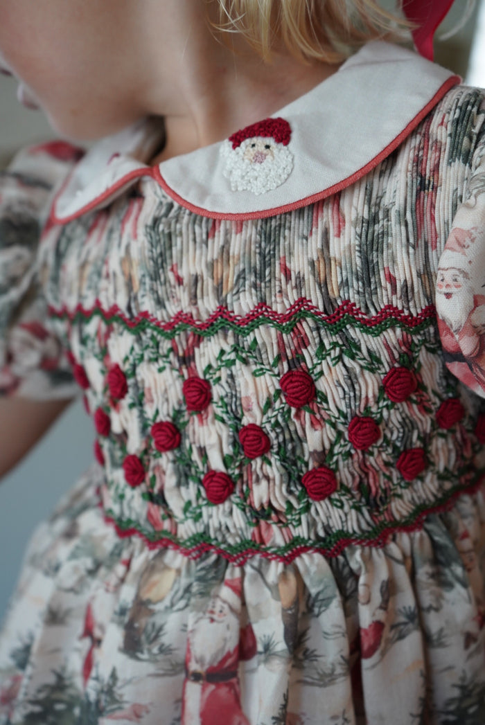 Close-up of red and green handsmocking on The Santa Claus Christmas outfit