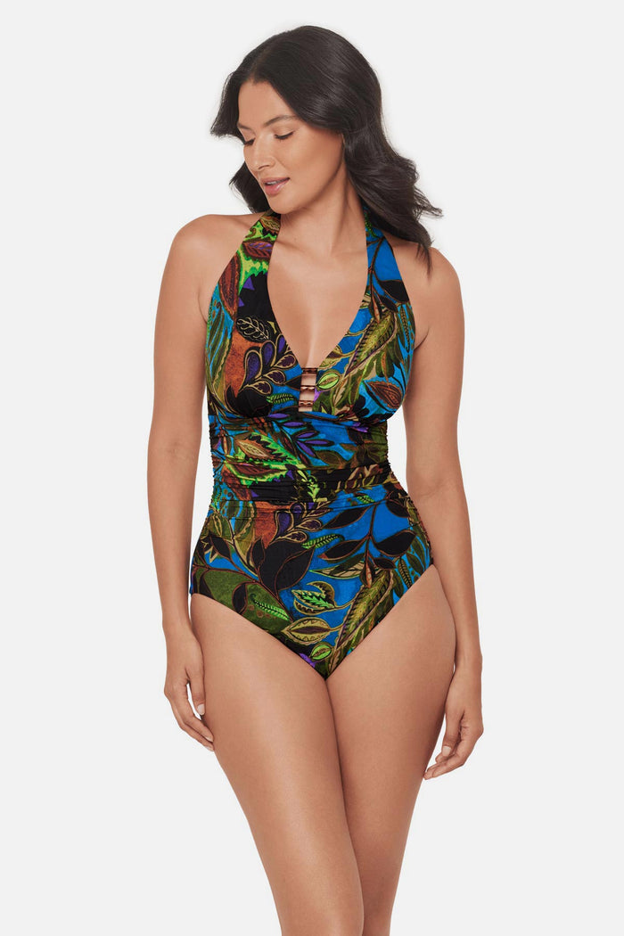 Woman wearing a multicolored abstract printed one-piece swimsuit