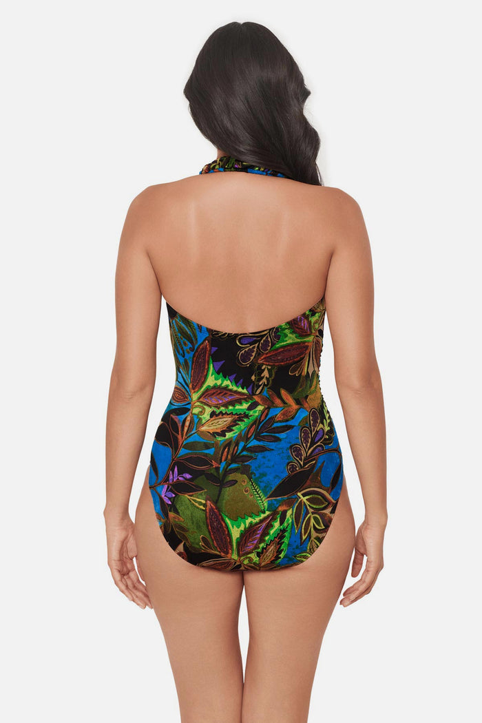 Woman faced away wearing a multicolored abstract printed one-piece swimsuit