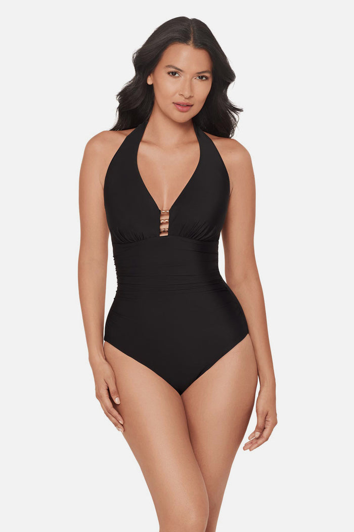Woman wearing a black one-piece swimsuit with bead details in the front