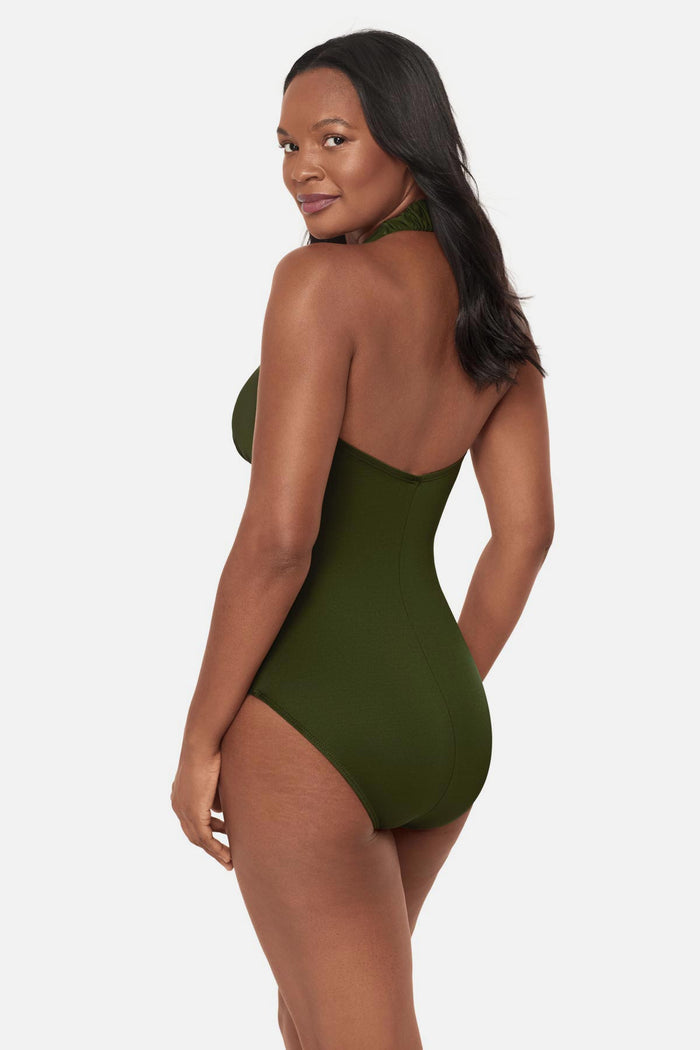 Woman turned left wearing a green one-piece swimsuit with bead details in the front