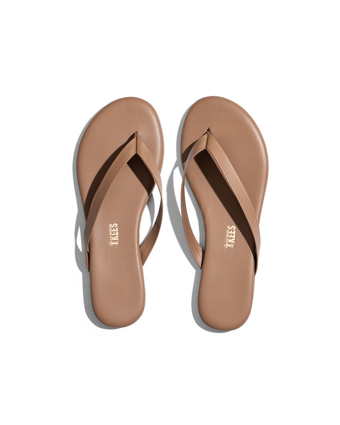 Top view of the TKEES Boyfriend Sandals in beach bum, showing a pair of flat thong sandals with a thin strap and round toe in warm tan.