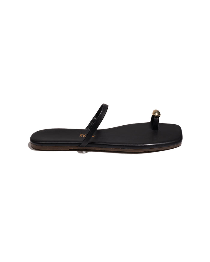 Side view of a single black TKEES Colette Sandal showing the slim silhouette.