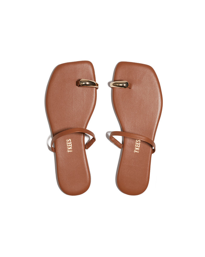 Top-down view of both natural TKEES Colette Sandals with gold dome toe hardware.
