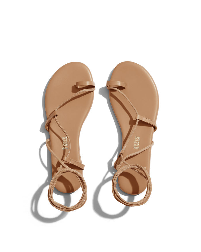 Top view of the TKEES Joe Sandals in hazelton, showing a pair of strappy flat sandals with thin crisscross straps and ankle tie in warm tan.