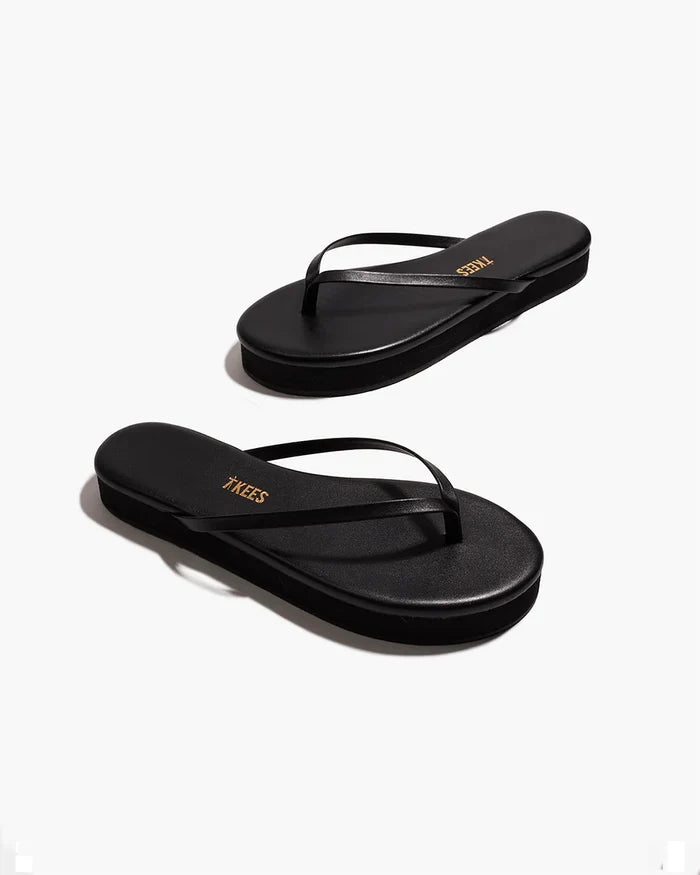 Angled view of both black TKEES Lily Platform Sandals showing the platform sole and slim thong strap.