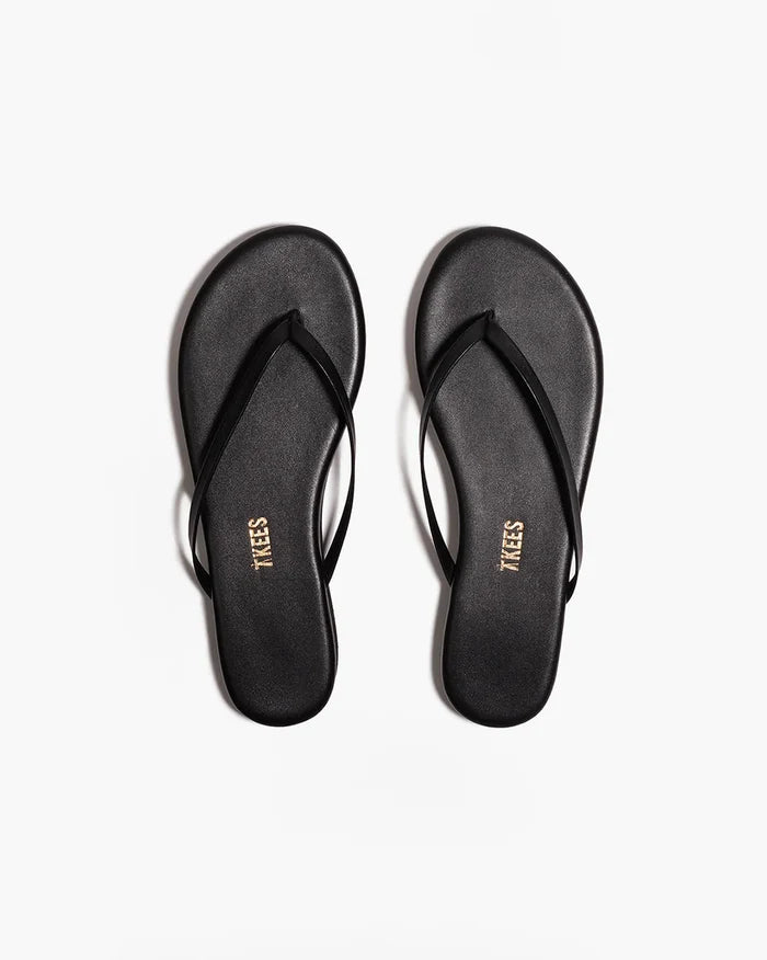 Top-down view of both black TKEES Lily Platform Sandals with TKEES logo on footbed.