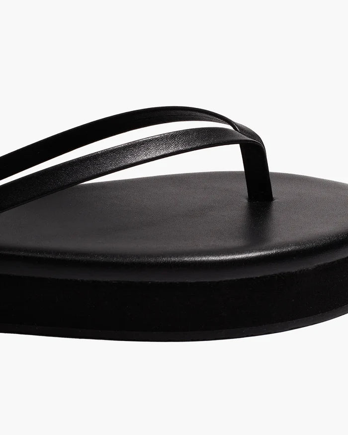 Close-up of the black thong strap and platform footbed detail on the TKEES Lily Platform Sandals.