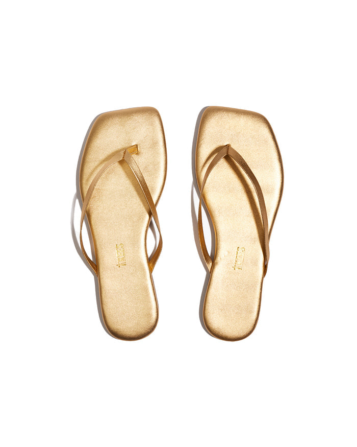 Top view of the TKEES Square Toe Lily Sandals in blink, showing gold metallic square-toe sandals with a thin thong strap.