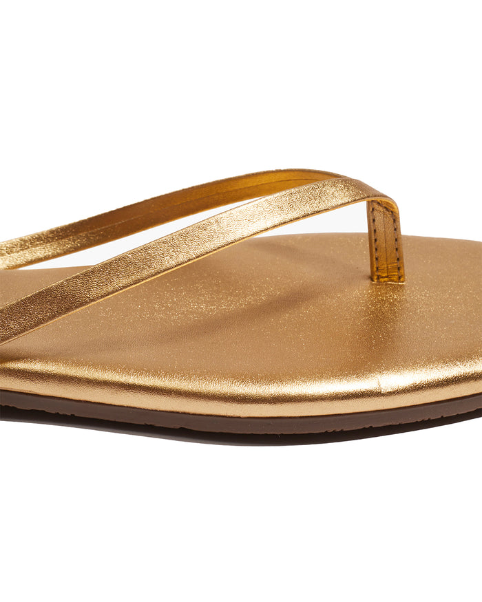 Close-up of the TKEES Square Toe Lily Sandals in blink showing the gold metallic thong strap and footbed detail.