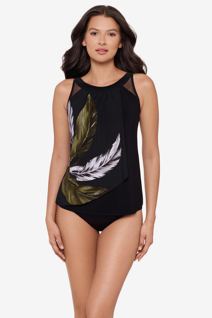 Woman wearing a green and white feather printed tankini top with mesh detail