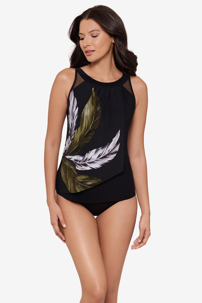 Woman wearing a green and white feather printed tankini top with mesh detail