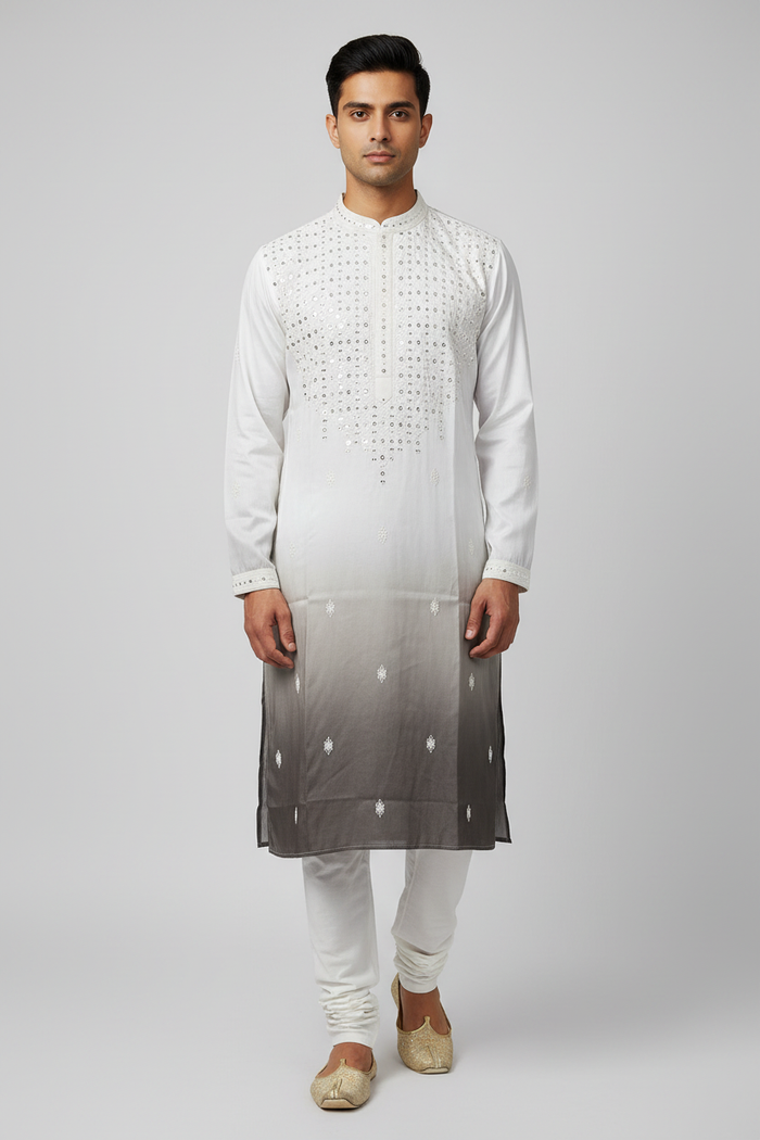 Male model wearing white ombre sequin kurta set with gold juttis - front pose