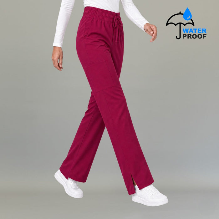 Women's 502 Fuchsia wide-leg scrub pants, walking three-quarter view with cargo pocket and slit hem
