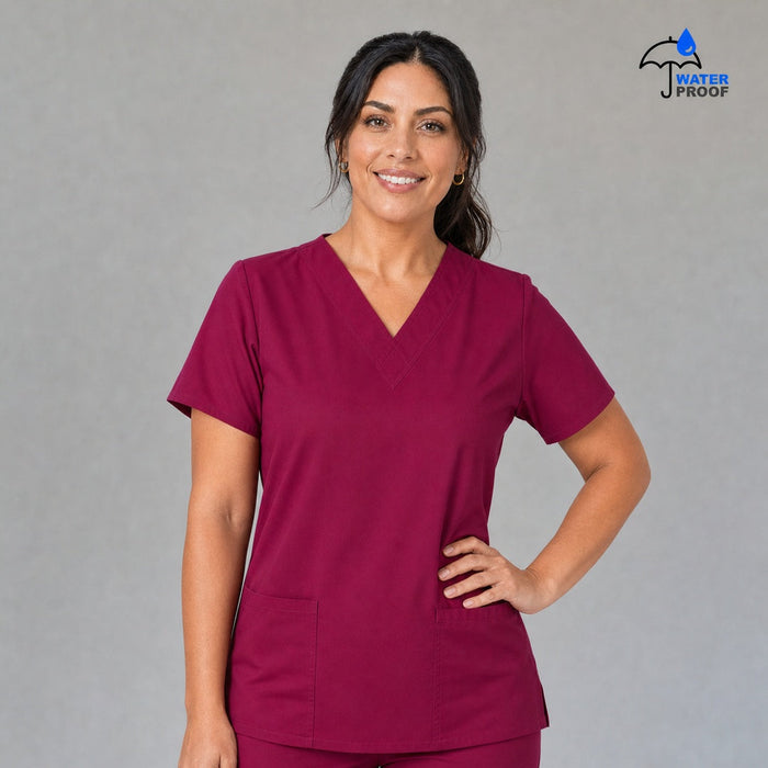 Women's FW 502 Fuchsia scrub top, front view with one hand on the hip