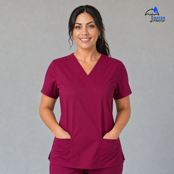 Women's FW 502 Fuchsia scrub top, front view with both hands in the patch pockets