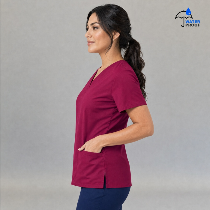 Women's FW 502 Fuchsia scrub top, side profile with one hand in a patch pocket