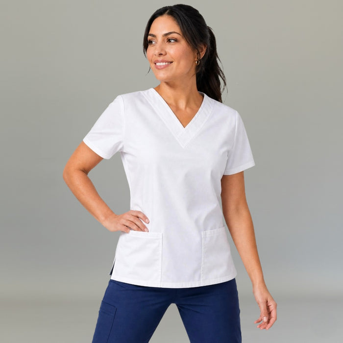 Women's white 502 scrub top with V-neck, short sleeves and two lower pockets, hand on hip — S-FOR-ME