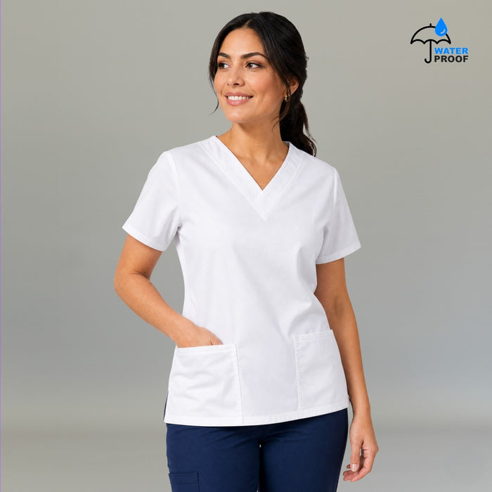 Women's white 502 scrub top shown with navy scrub pants in a full-body walking pose — S-FOR-ME