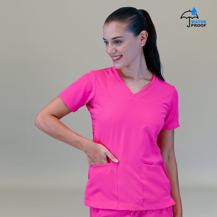 Women's Style 530 Fuchsia scrub top, front view with one hand in a pocket