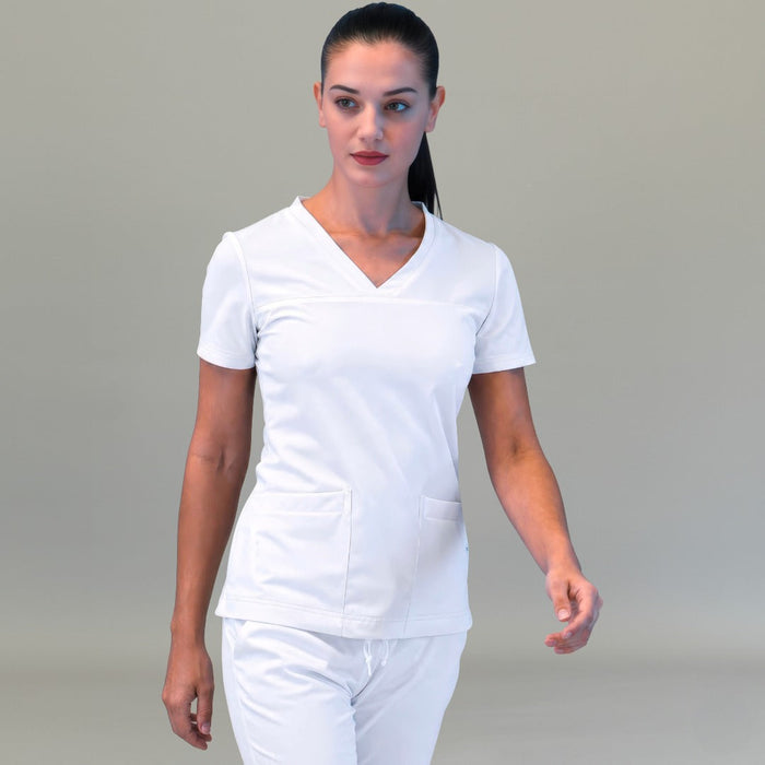 Women's Style 530 White scrub top, front walking view with matching white pants