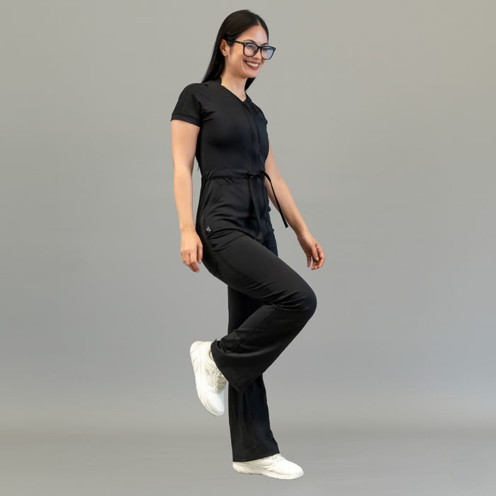 Side movement view of women’s Black Super Stretch scrub jumpsuit