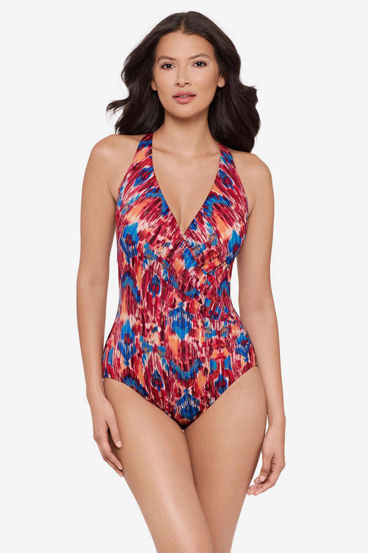 Woman wearing a multicolored one-piece swimsuit with a V neckline