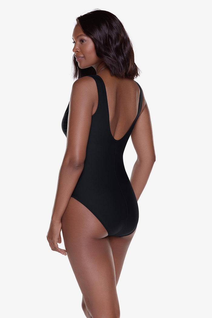Woman turned left wearing a black one-piece swimsuit