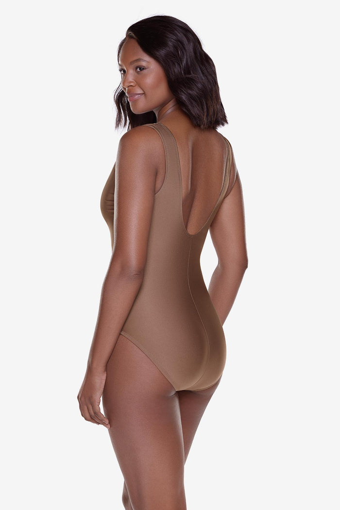 Woman turned left wearing a brown one-piece swimsuit