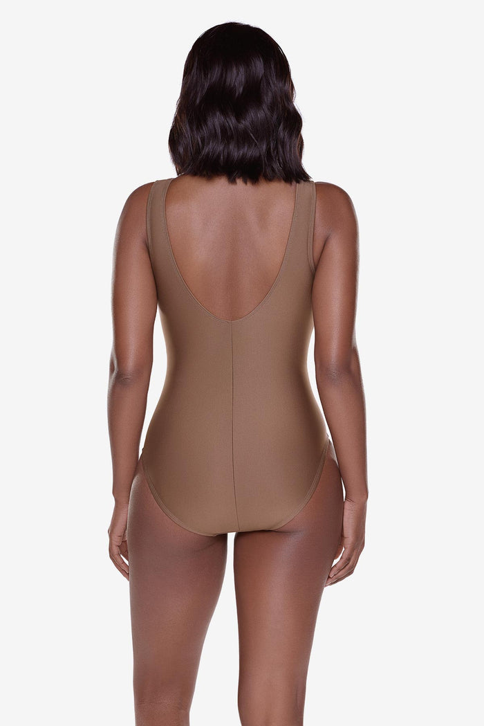 Woman turned away wearing a brown one-piece swimsuit
