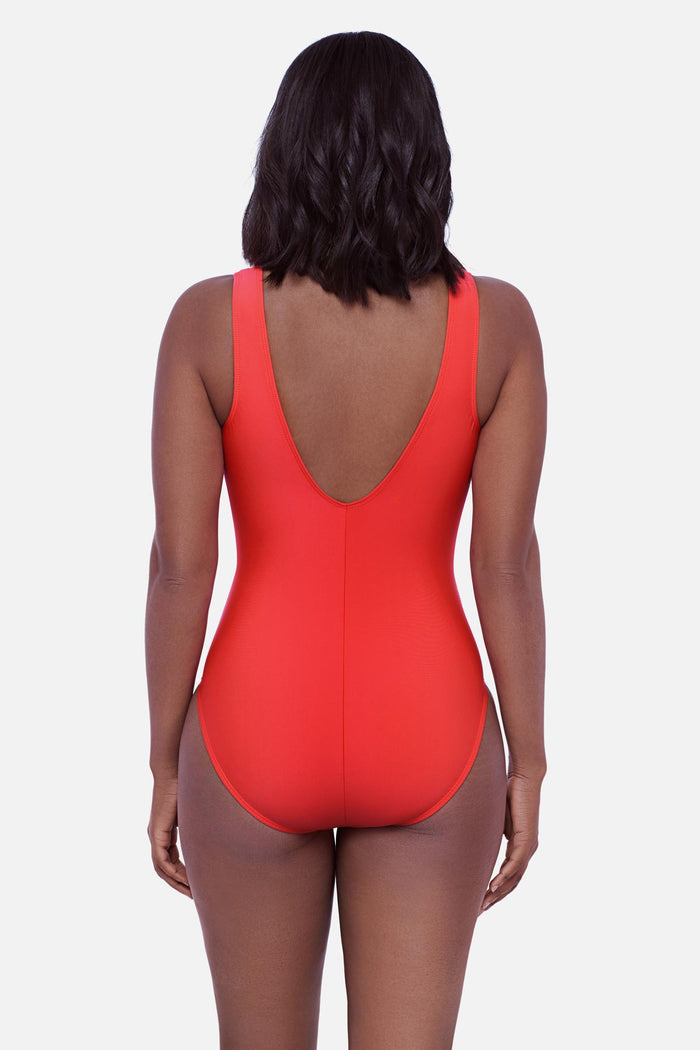 Woman faced away wearing an orange one-piece swimsuit